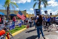 A republican woman waves a flag and faces a Democrat holding a `Move On` sign in vote counting protest