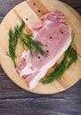 Repulsed pork steaks on a wooden cutting board with dill and spices Royalty Free Stock Photo