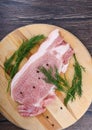 Repulsed pork steaks on a wooden cutting board with dill and spices Royalty Free Stock Photo