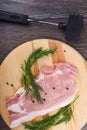 Repulsed pork steaks on a wooden cutting board with dill and spices Royalty Free Stock Photo