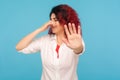 Repulsion to fart smell. Portrait of girl with fancy red hair frowning in disgust, showing stop gesture Royalty Free Stock Photo