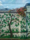 Rescoes behind houses are painted with plants and fish and flowers living