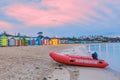 Rescue boat on a beach with huts Royalty Free Stock Photo