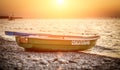 Rescue boat on the gravel beach on sunset time. Translation: lifeboat Royalty Free Stock Photo