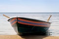 Rescue boat with paddles on blue background. Blue sky background. Transportation background. Holiday summer beach Royalty Free Stock Photo