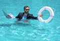 Rescue business. Business man in suit hold laptop and rescue lifebuoy in swim pool. Rescue swimming ring for businessman