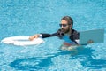 Rescue business. Business man in suit hold laptop and rescue lifebuoy in swim pool. Rescue swimming ring for businessman