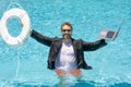 Rescue business. Business man in suit hold laptop and rescue lifebuoy in swim pool. Rescue swimming ring for businessman