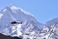 Rescue helicopter in flight over snow capped Royalty Free Stock Photo