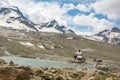 Rescue helicopter landing near mountain lake providing assistance. Royalty Free Stock Photo