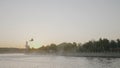 Rescue helicopter over city. Action. Helicopter flies over city canal on background of sunset. Rescue helicopter over Royalty Free Stock Photo