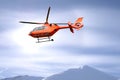 Rescue helicopter over mountain summits