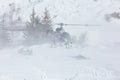 Rescue helicopter during a snow storm in the mountains