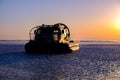 Rescue hovercraft on the ice in sunrise