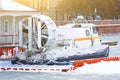 Rescue hovercraft at the pier at the frozen river in winter.