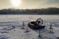 Rescue hovercraft on the snow covered ice of lake in sunny winter day