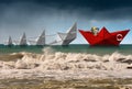 Rescue and Leadership concept - Paper boats in a rough sea Royalty Free Stock Photo