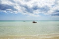 Rescue rowing boat on the sea against a cloudy and sunny sky. Beautiful view. Crystal clear water. Paradise beach Royalty Free Stock Photo