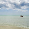 Rescue rowing boat on the sea against a cloudy and sunny sky. Beautiful view. Crystal clear water. Paradise beach Royalty Free Stock Photo