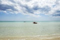 Rescue rowing boat on the sea against a cloudy and sunny sky. Beautiful view. Crystal clear water. Paradise beach Royalty Free Stock Photo