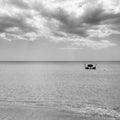 Rescue rowing boat on the sea against a cloudy and sunny sky. Beautiful view. Crystal clear water. Paradise beach Royalty Free Stock Photo