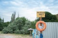 Rescue station on beach on sunny day. sign on the shore. Text in Ukrainian: rescue post. Red life preserver Royalty Free Stock Photo