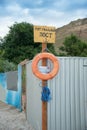 Rescue station on beach on sunny day. sign on the shore. Text in Ukrainian: rescue post. Red life preserver Royalty Free Stock Photo