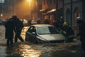 rescue team moving stranded car on flooded street at dusk Royalty Free Stock Photo