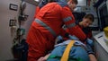 Rescue team of paramedics giving first aid help to victim in emergency car