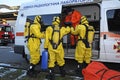 Rescue team training of chemical decontamination: rescuers in protective ensembles preparing equipment