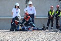 A rescue team in training sessions provides first aid to an electrician mannequin who has been injured by electric shock.