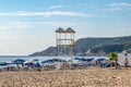 Rescue tower at Kleopatra beach in Alanya. Lots of sun loungers with umbrellas against the