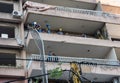 Rescue workers removing debris from a balcony