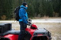 Rescuer Inspecting Woods Area by Atv Quad Bike