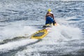 Rescuer in life vest rides a water scooter on the water Royalty Free Stock Photo