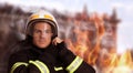 Rescuer wearing uniform and helmet. Professional firefighter