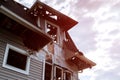 Rescuers firefighters extinguish a fire on the roof. The building after the fire. Burnt window. Ruined house. Catastrophe.