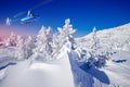 Rescuers looking for missing skiers and snowboarders in mountains, snowy forest with help of helicopter. Rescue Royalty Free Stock Photo