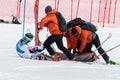 Rescuers provide first aid to sportsman before evacuated on rescue stretcher from mountain