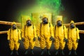 Rescuers in a radiation protection suit against the background of barrels of radioactive waste. The concept of nature protection,
