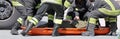 rescuers recover the injured with a special orange stretcher to