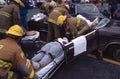 Rescuers remove an injured from a car accident