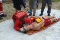 Rescuers team carrying sufferer on a stretcher helping him to get to the first aid post, training Royalty Free Stock Photo