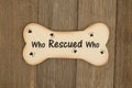 Rescuing a dog message on wood dog bone Royalty Free Stock Photo