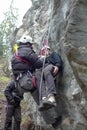 Rescuing an injured rock climber with a system of ropes and climbing equipment