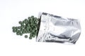 Resealable aluminum bag with green pill tablets