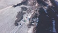 Research base located in mountains. Clip. Top view of trailers located high in mountains among snow. Research base in