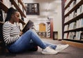 Research, book and a black woman in a library for reading, college knowledge or studying on the floor. Scholarship Royalty Free Stock Photo