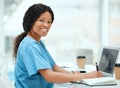 Research keeps me busy. a young female doctor using a laptop while working at a hospital. Royalty Free Stock Photo