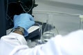 Research scientist hand with blue chemical protective gloves using volumetric flask for doing experiment to determine the levels Royalty Free Stock Photo